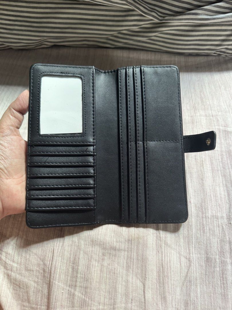 Steve Madden Black Long Wallet (Category: Wallets & Card holders) located in Las Pinas. Submitted by nautikath18 (Listing ID 1468552180, Image 3). Description: - Brand: Steve Madden - Color: Classic black with elegant gold-tone hardware - Closure: Secure front flap with snap button - Exterior: Convenient back zipper pocket - Interior: Multiple card slots and a clear ID window - Condition: Clean interior, very well-maintained, ideal for everyday u