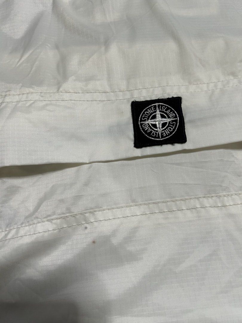 Stone island wind breaker (Category: Coats, Jackets and Outerwear) located in Trece Martires City. Submitted by flip_flips (Listing ID 1468527002, Image 3). Description: Stone island wind breaker -Dimes: 30 width 32 length -Excellent condition -9.5/10 color rate -issue: minor dot stains, cut wash tag.