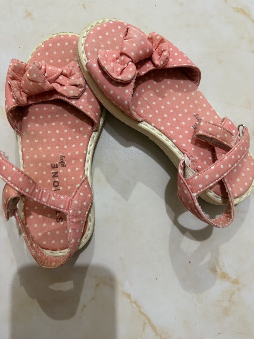 Stone Play Pink Polka Dot Sandals Size 18cm (Category: Flats & Sandals) located in Taguig. Submitted by heideewatts (Listing ID 1468618616, Image 1). Description: - Brand/Style: Stone Play pink sandals with white polka dots - Size: 19vm length (measured with tape) - Design Details: Adorable front bow and adjustable ankle strap with metal buckle - Comfort & Safety: Sturdy, textured soles with decent grip - Condition: Pre-owned with light wear on t