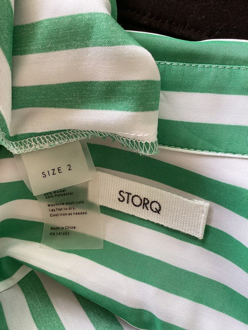 STORQ Green White Striped Button Down Shirt Size 2 (Category: Shirts) located in Bacoor. Submitted by cts217 (Listing ID 1468507593, Image 3). Description: - Brand: STORQ - Design: Green and white vertical stripes - Size: 2 - Features: Long sleeves, collar, front button closure, and one chest pocket - Material: 65% modal and 35% polyester blend - Care: Machine washable - Origin: Made in China.