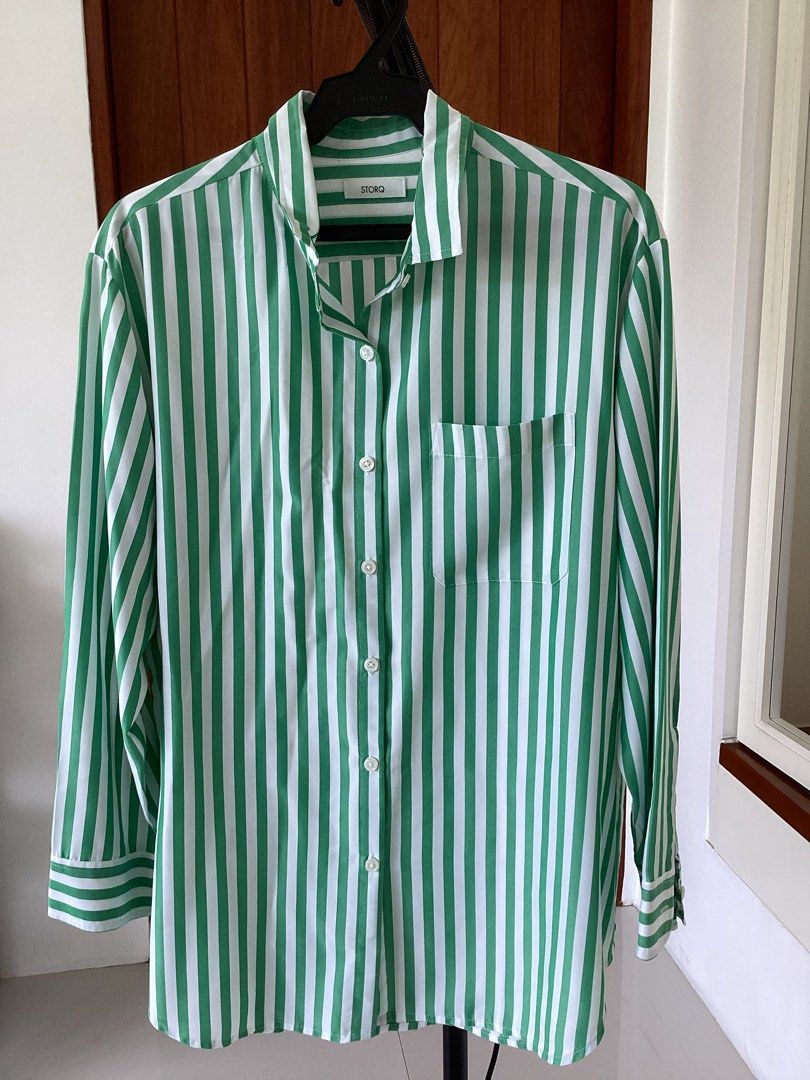 STORQ Green White Striped Button Down Shirt Size 2 (Category: Shirts) located in Bacoor. Submitted by cts217 (Listing ID 1468507593, Image 1). Description: - Brand: STORQ - Design: Green and white vertical stripes - Size: 2 - Features: Long sleeves, collar, front button closure, and one chest pocket - Material: 65% modal and 35% polyester blend - Care: Machine washable - Origin: Made in China.