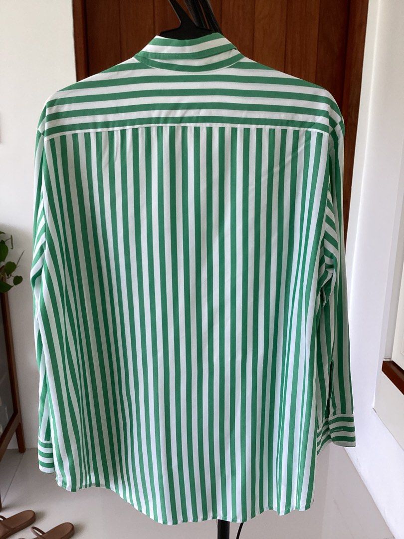 STORQ Green White Striped Button Down Shirt Size 2 (Category: Shirts) located in Bacoor. Submitted by cts217 (Listing ID 1468507593, Image 2). Description: - Brand: STORQ - Design: Green and white vertical stripes - Size: 2 - Features: Long sleeves, collar, front button closure, and one chest pocket - Material: 65% modal and 35% polyester blend - Care: Machine washable - Origin: Made in China.