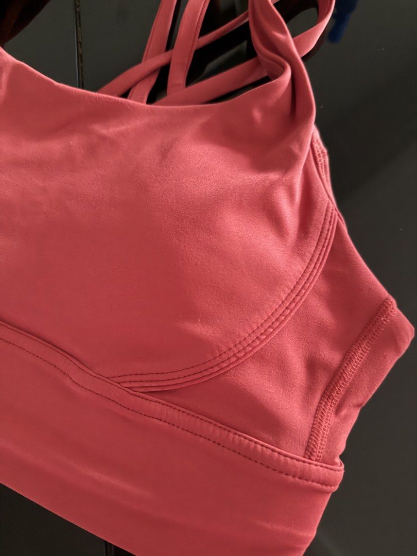 Strappy Sports Bra Pink Red (Category: Activewear) located in Mandaluyong City. Submitted by declutteringmylife101 (Listing ID 1468578049, Image 2). Description: - Color: Pinkish-red - Design: Trendy criss-cross back straps - Support: Wide underbust band for extra stability - Comfort: Soft and stretchy fabric - Padding: Includes removable cups with accessible inner slots - Condition: Brand new/Excellent quality - Perfect for gym, yoga, or everyda