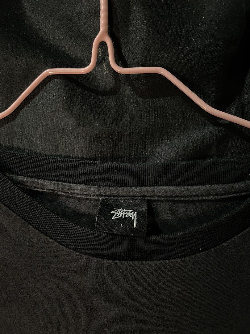 Stussy Graphic Print Tee Black Size L (Category: Tshirts & Polo Shirts ) located in Cebu City. Submitted by selected_fit (Listing ID 1468651660, Image 3). Description: - Brand: Stussy - Color: Black with bold front graphic and small sleeve logo - Size: Large (tag attached) - Material: 100% cotton, Made in China - Condition: Light fade from washing, great vintage streetwear look - Fit: Ribbed crew neckline, ideal for daily casual wear.