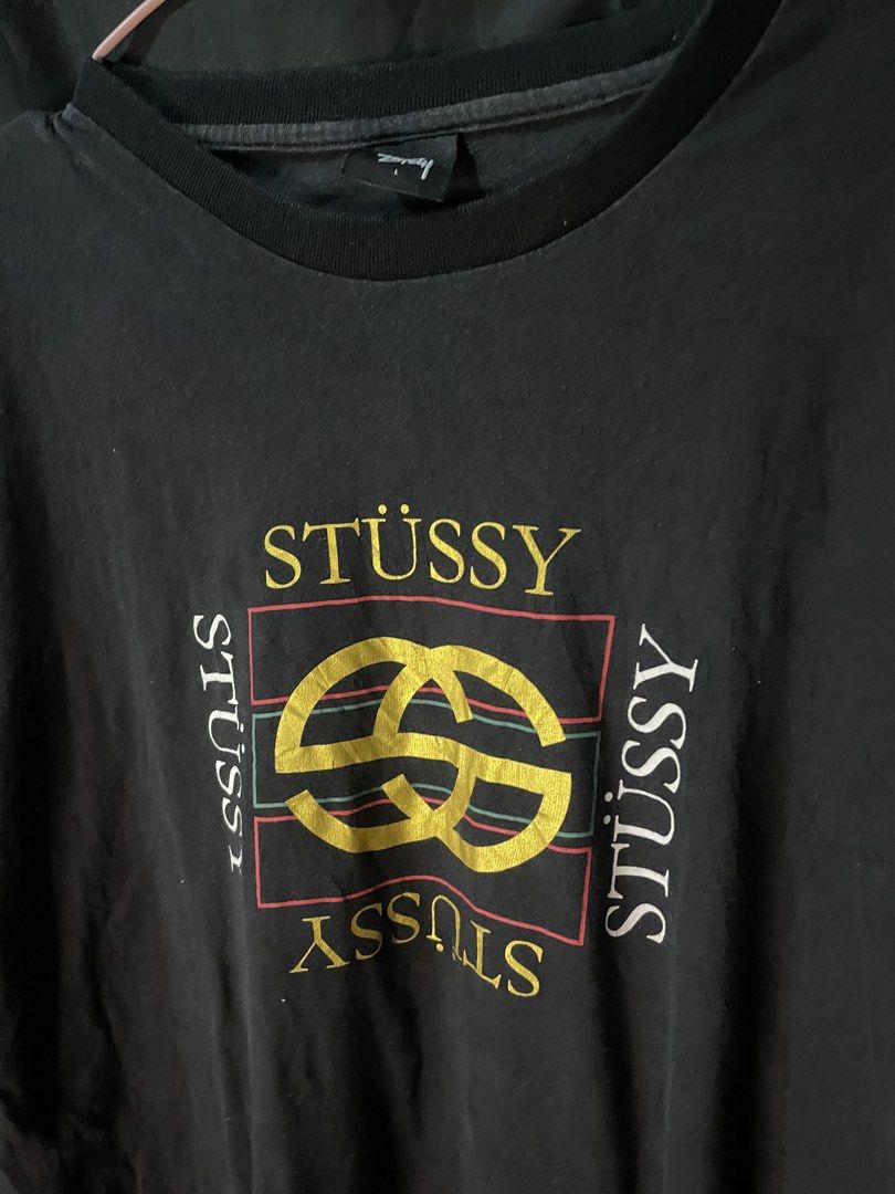 Stussy Graphic Print Tee Black Size L (Category: Tshirts & Polo Shirts ) located in Cebu City. Submitted by selected_fit (Listing ID 1468651660, Image 2). Description: - Brand: Stussy - Color: Black with bold front graphic and small sleeve logo - Size: Large (tag attached) - Material: 100% cotton, Made in China - Condition: Light fade from washing, great vintage streetwear look - Fit: Ribbed crew neckline, ideal for daily casual wear.
