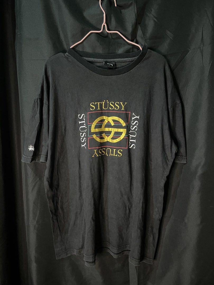 Stussy Graphic Print Tee Black Size L (Category: Tshirts & Polo Shirts ) located in Cebu City. Submitted by selected_fit (Listing ID 1468651660, Image 1). Description: - Brand: Stussy - Color: Black with bold front graphic and small sleeve logo - Size: Large (tag attached) - Material: 100% cotton, Made in China - Condition: Light fade from washing, great vintage streetwear look - Fit: Ribbed crew neckline, ideal for daily casual wear.