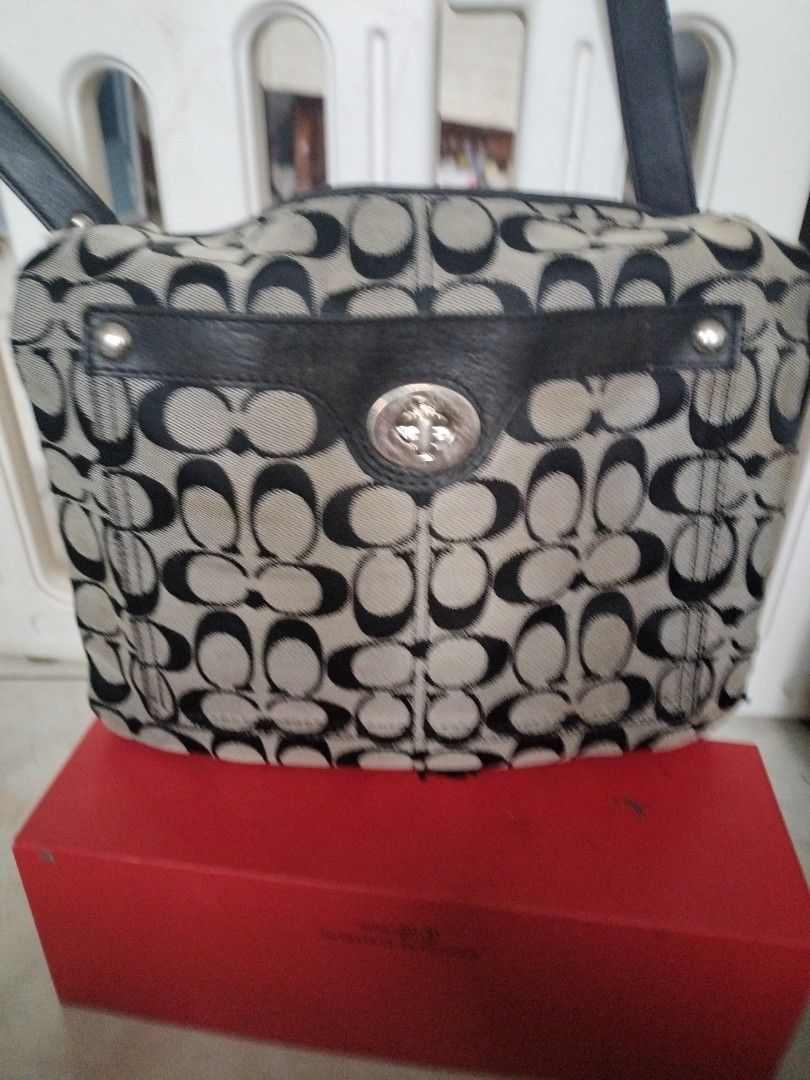 Super Sale Coach bag (Category: Cross-body Bags) located in Leyte. Submitted by janiceql8414443 (Listing ID 1468570982, Image 2). Description: - Color/Material: Black canvass with leather - Hardware: Silver-tone round metal ring and snap buttons - Condition: Heavily used.Damaged strap, with flaking near the metal buckle and adjustment areas...
