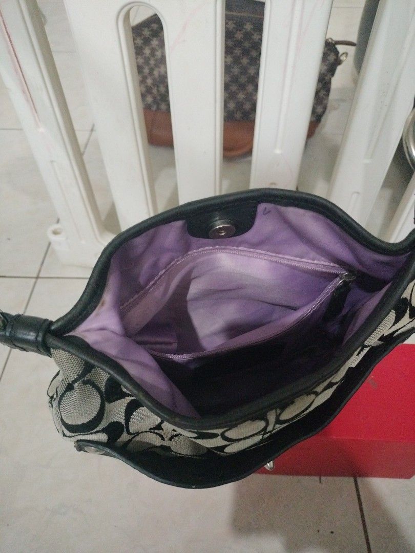 Super Sale Coach bag (Category: Cross-body Bags) located in Leyte. Submitted by janiceql8414443 (Listing ID 1468570982, Image 3). Description: - Color/Material: Black canvass with leather - Hardware: Silver-tone round metal ring and snap buttons - Condition: Heavily used.Damaged strap, with flaking near the metal buckle and adjustment areas...