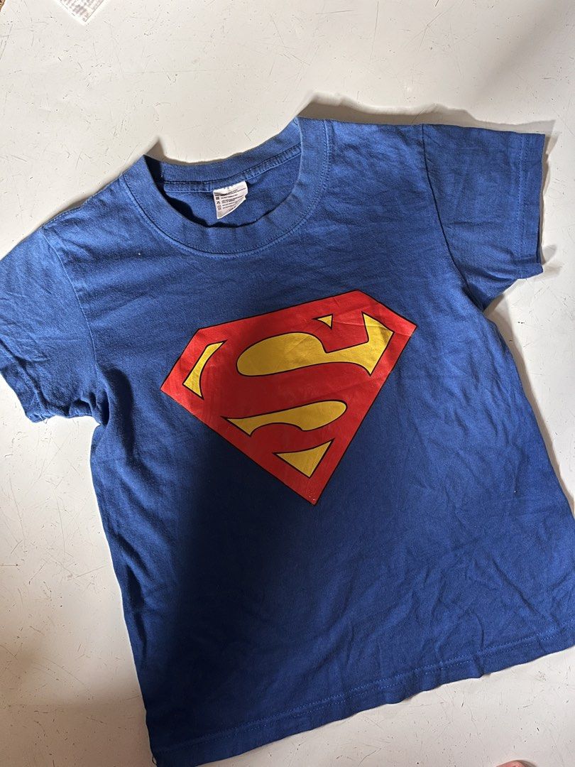 Superman Blue T-Shirt (Category: Shirts) located in Dagupan City. Submitted by shanadongsb (Listing ID 1468593581, Image 1). Description: - Authentic DC Comics Superman t-shirt in classic blue - Features the iconic red and yellow Superman logo on the chest - Crew neck and short sleeves for everyday comfort - Size: XS - Condition: Clean fabric, no stains, holes, or tears - Great casual wear for fans and collectors.