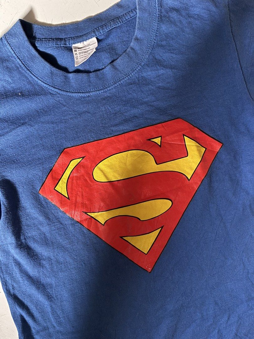 Superman Blue T-Shirt (Category: Shirts) located in Dagupan City. Submitted by shanadongsb (Listing ID 1468593581, Image 2). Description: - Authentic DC Comics Superman t-shirt in classic blue - Features the iconic red and yellow Superman logo on the chest - Crew neck and short sleeves for everyday comfort - Size: XS - Condition: Clean fabric, no stains, holes, or tears - Great casual wear for fans and collectors.