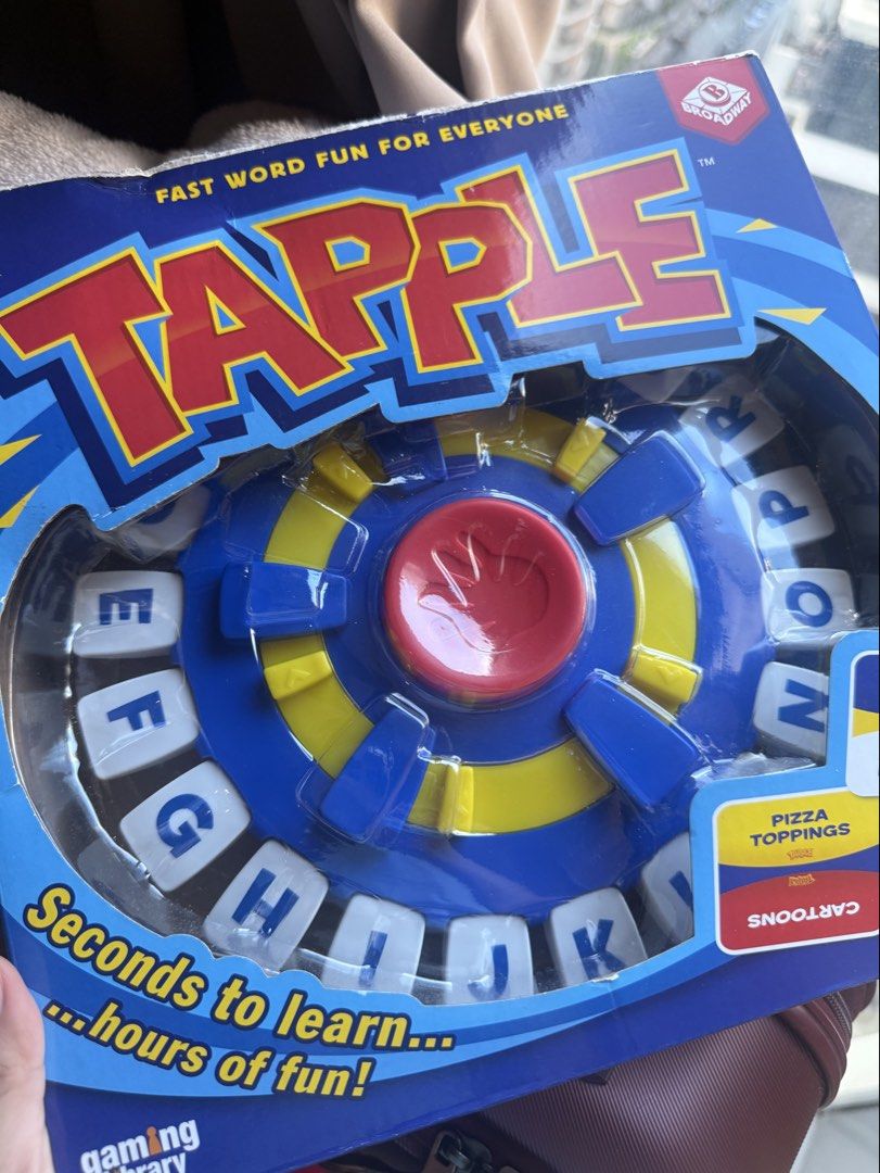 Tapple Fast Word Game (Category: Board Games & Puzzles) located in Taguig. Submitted by decluttering_tita2 (Listing ID 1468599311, Image 1). Description: - Product: Broadway fast-paced word game - Ideal for: Family game nights, parties, and group activities for kids and adults - Gameplay: Pick a category, beat the timer, and name answers .