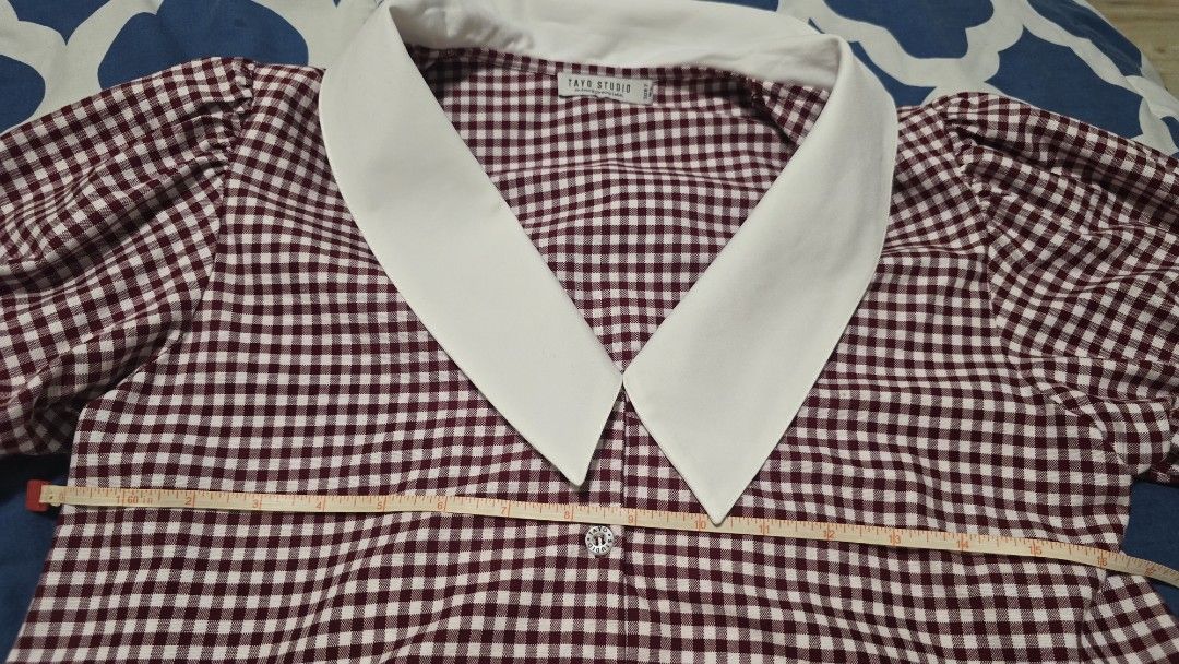 TAYO STUDIO Burgundy Gingham Collared Blouse Size 2 (Category: Blouses) located in Las Pinas. Submitted by insouciant_worrier (Listing ID 1468674676, Image 3). Description: - Brand: Tayo Studio - Size: 2 (Fits Medium to Large) - Pattern: Burgundy & white gingham - Details: Contrast white pointed collar and sleeve cuffs, button-down front with decorative buttons, puff short sleeves - Measurements: ~15" pit to pit, ~18" total length - Condition: Ex