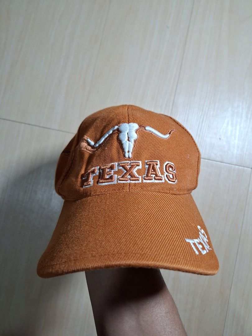 Texas Longhorns Orange Embroidered Cap (Category: Caps & Hats) located in Baguio. Submitted by restyrille77846 (Listing ID 1468642655, Image 1). Description: - Vibrant orange Texas Longhorns baseball cap - Eye-catching embroidered longhorn skull graphic and text details - Stitched Texas flag patch on the side - Adjustable strap closure with Texas branding for a custom fit - Great collectible item for fans of the team and the Lone Star State.