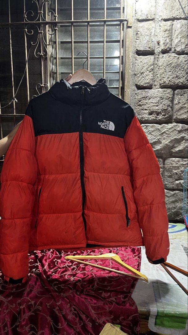 The North Face 700 Nuptse Puffer Jacket Orange Black (Category: Coats, Jackets and Outerwear) located in Caloocan City. Submitted by lucky_jhonel (Listing ID 1468659219, Image 3). Description: - Brand: The North Face - Model: 700 Nuptse Puffer Jacket - Colourway: Bright Orange and Black - Fit: Classic boxy design with a high collar - Details: Embroidered logo on the chest, full zip front, and side zippered pockets - Condition/Use: Great winter ou