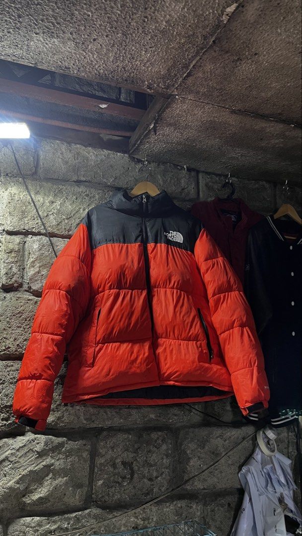 The North Face 700 Nuptse Puffer Jacket Orange Black (Category: Coats, Jackets and Outerwear) located in Caloocan City. Submitted by lucky_jhonel (Listing ID 1468659219, Image 1). Description: - Brand: The North Face - Model: 700 Nuptse Puffer Jacket - Colourway: Bright Orange and Black - Fit: Classic boxy design with a high collar - Details: Embroidered logo on the chest, full zip front, and side zippered pockets - Condition/Use: Great winter ou