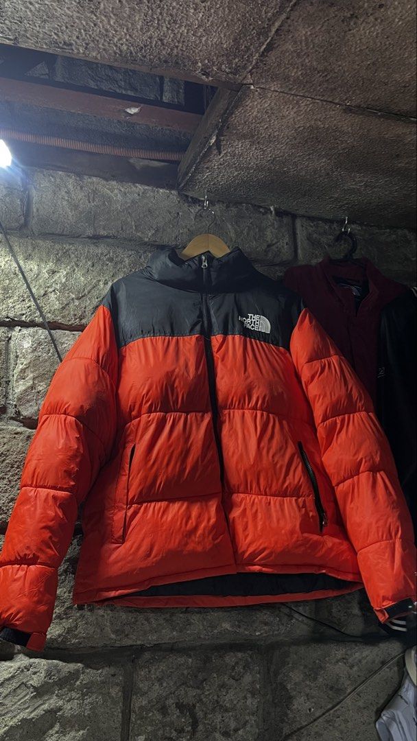The North Face 700 Nuptse Puffer Jacket Orange Black (Category: Coats, Jackets and Outerwear) located in Caloocan City. Submitted by lucky_jhonel (Listing ID 1468659219, Image 2). Description: - Brand: The North Face - Model: 700 Nuptse Puffer Jacket - Colourway: Bright Orange and Black - Fit: Classic boxy design with a high collar - Details: Embroidered logo on the chest, full zip front, and side zippered pockets - Condition/Use: Great winter ou