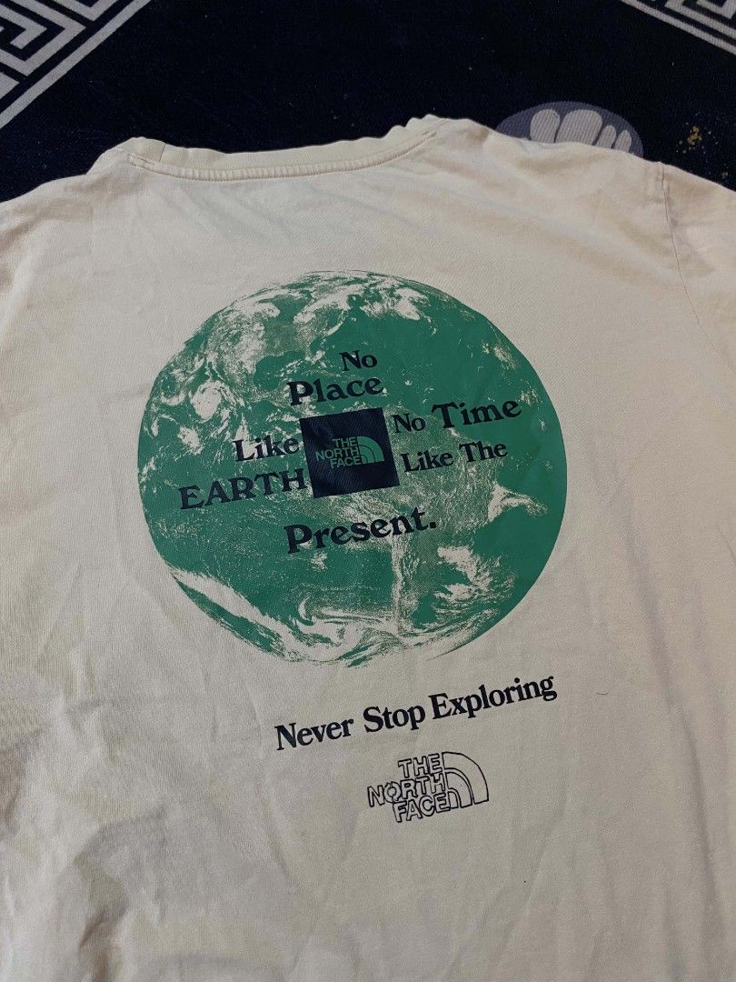 The North Face Earth Graphic Tee Off-White (Category: Tshirts & Polo Shirts ) located in Manila. Submitted by thrift_sta.20 (Listing ID 1468568362, Image 3). Description: - Brand: The North Face - Color: Off-white - Size: Men's US Large / Asia Extra Large - Material: 100% Cotton - Design: Small TNF chest logo with a large green 'No Place Like Earth Like The Present' back graphic - Fit: Regular short sleeve crewneck.