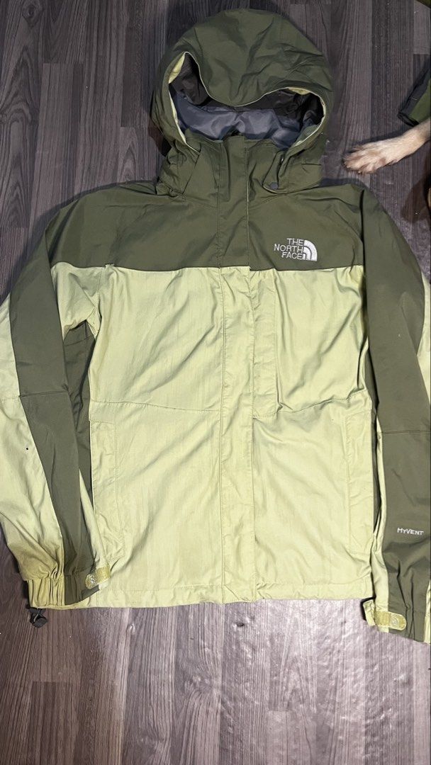 The North Face HyVent Olive Green Jacket (Category: Coats, Jackets and Outerwear) located in Caloocan City. Submitted by lucky_jhonel (Listing ID 1468658705, Image 1). Description: - Brand: The North Face HyVent - Colorway: Olive and light green two-tone - Features: Zip-up front with high collar, adjustable hood, and underarm pit zips for ventilation - Cuffs: Adjustable Velcro straps - Branding: Embroidered logo on chest and sleeve - Condition: E