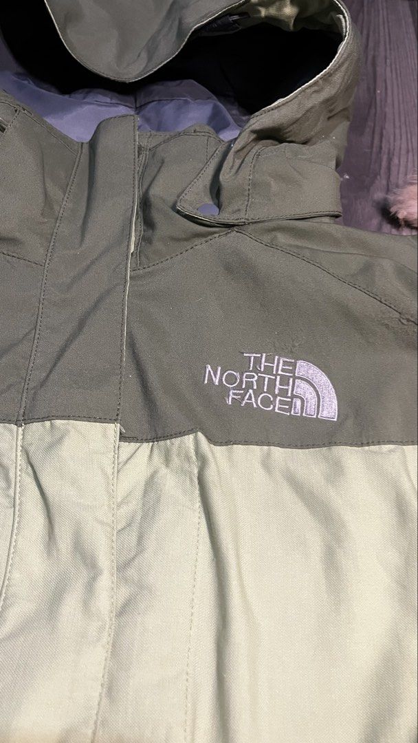 The North Face HyVent Olive Green Jacket (Category: Coats, Jackets and Outerwear) located in Caloocan City. Submitted by lucky_jhonel (Listing ID 1468658705, Image 3). Description: - Brand: The North Face HyVent - Colorway: Olive and light green two-tone - Features: Zip-up front with high collar, adjustable hood, and underarm pit zips for ventilation - Cuffs: Adjustable Velcro straps - Branding: Embroidered logo on chest and sleeve - Condition: E