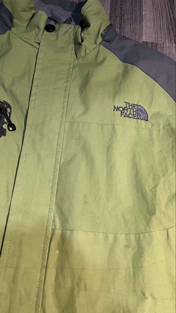 The North Face Summit Series Green Grey Jacket (Category: Coats, Jackets and Outerwear) located in Caloocan City. Submitted by lucky_jhonel (Listing ID 1468658960, Image 3). Description: - Brand: The North Face Summit Series - Color: Green and dark grey color block - Material/Feature: Waterproof, durable outdoor gear with a high collar - Pockets: Convenient vertical chest pocket with zip - Branding: Embroidered logo on chest and shoulder - Condit