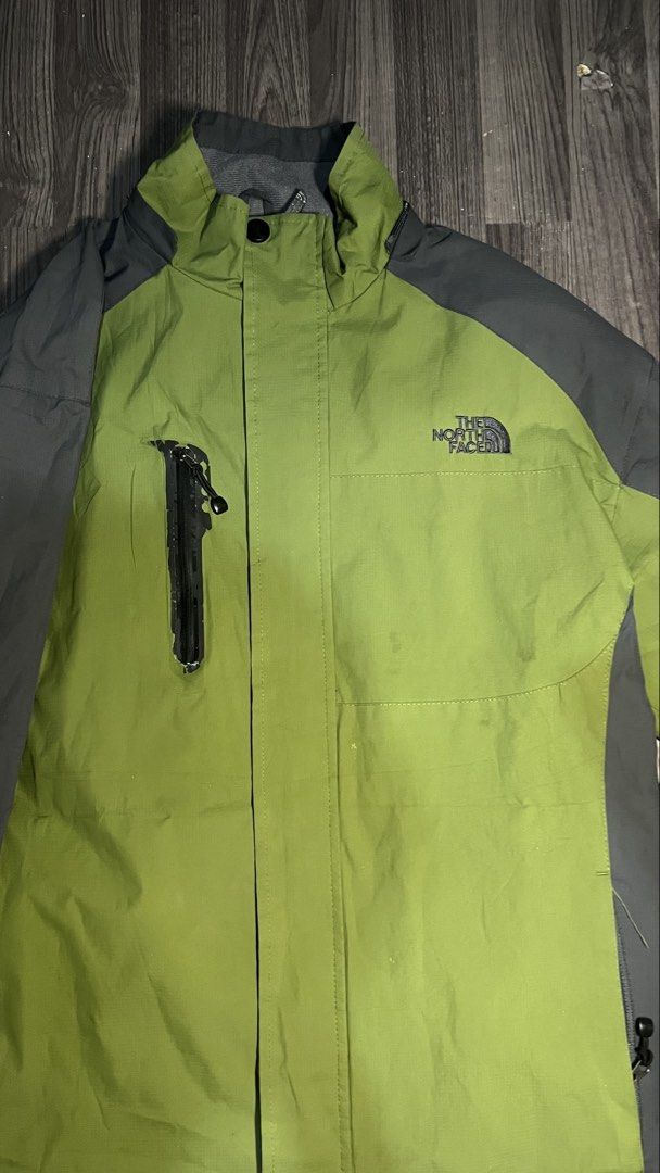 The North Face Summit Series Green Grey Jacket (Category: Coats, Jackets and Outerwear) located in Caloocan City. Submitted by lucky_jhonel (Listing ID 1468658960, Image 2). Description: - Brand: The North Face Summit Series - Color: Green and dark grey color block - Material/Feature: Waterproof, durable outdoor gear with a high collar - Pockets: Convenient vertical chest pocket with zip - Branding: Embroidered logo on chest and shoulder - Condit