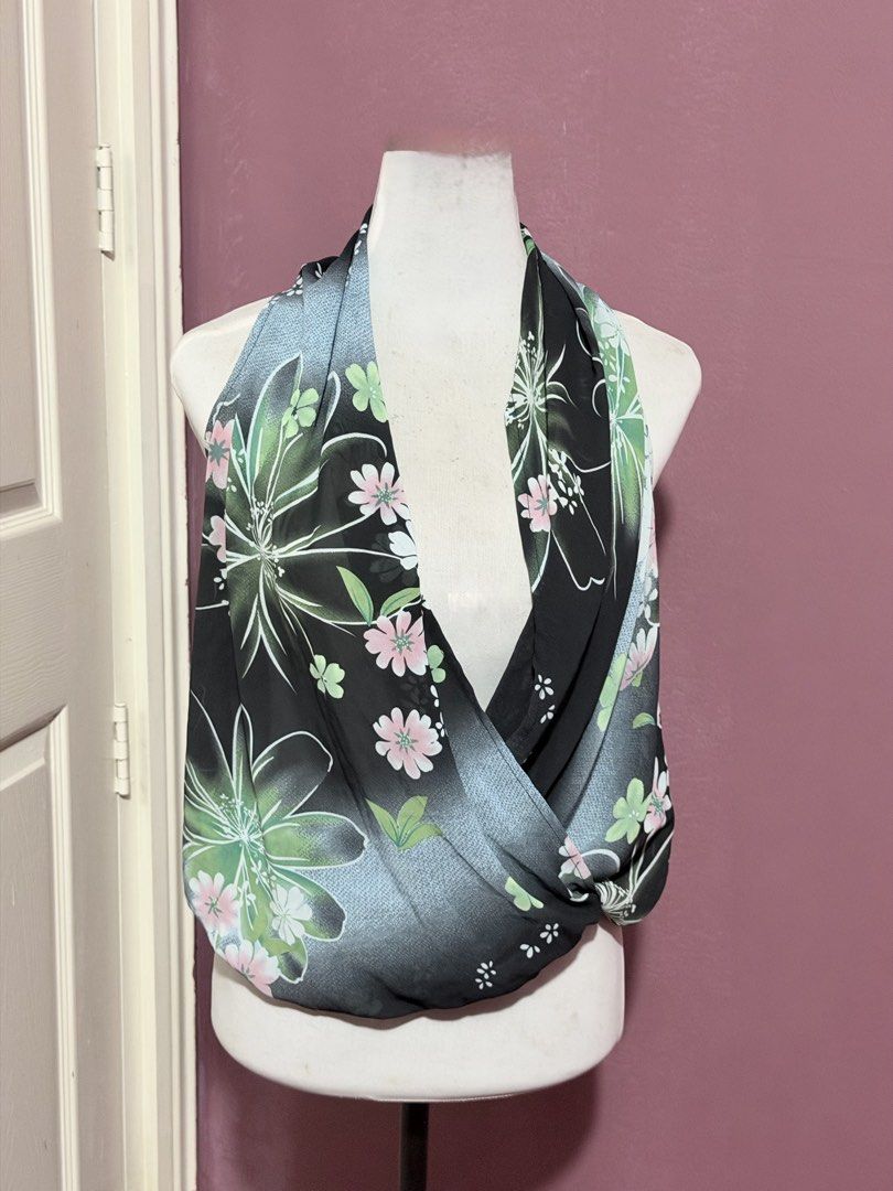 Thin floral low neck aesthetic top whimsy (Category: Sleeveless) located in Manila. Submitted by thatgirl0001 (Listing ID 1468598834, Image 1). Description: - Style: Sleeveless top with a draped wrap-around front design - Design: Black base with colorful pink floral pattern and light blue panel accents - Material: Lightweight fabric, ideal for warm weather styling - Condition: Excellent, ready to wear - Perfect for: Casual outings, dates, or summ
