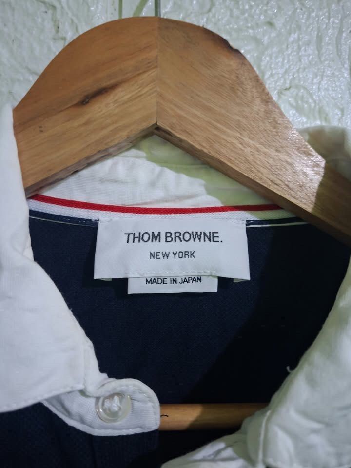 Thom Browne Polo Shirt (Category: Others Tops) located in Bulacan. Submitted by bleue.finds (Listing ID 1468574941, Image 3). Description: Thom Browne Polo Shirt - size 2 - 20 width - 26 length - as new - minor yellowish stain on collar - good condition .