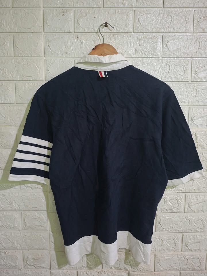 Thom Browne Polo Shirt (Category: Others Tops) located in Bulacan. Submitted by bleue.finds (Listing ID 1468574941, Image 2). Description: Thom Browne Polo Shirt - size 2 - 20 width - 26 length - as new - minor yellowish stain on collar - good condition .