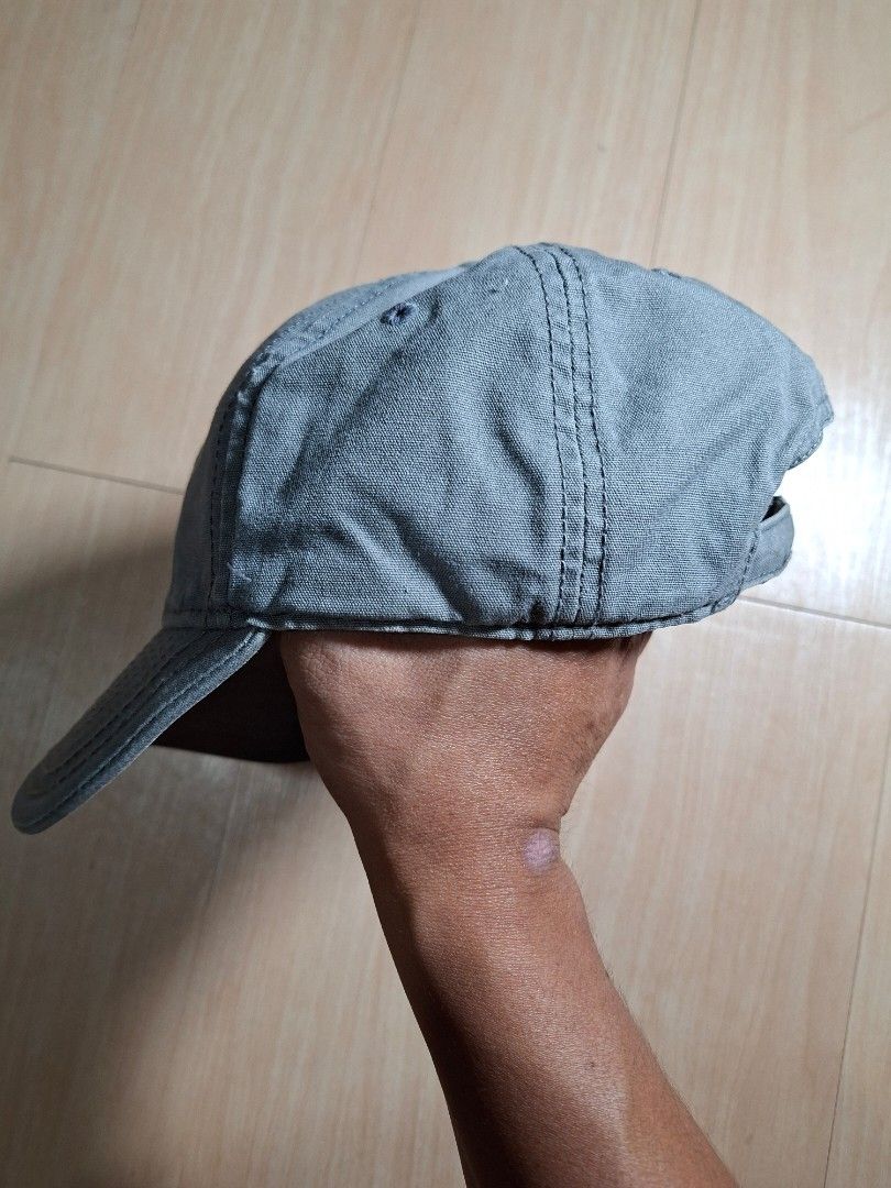 Timberland Grey Baseball Cap with Leather Patch (Category: Caps & Hats) located in Baguio. Submitted by restyrille77846 (Listing ID 1468642511, Image 2). Description: - Authentic Timberland cap in versatile grey - Sturdy canvas material with structured brim and ventilation eyelets - Features iconic diamond-shaped leather patch with tree logo and 1973 branding - Adjustable strap with metal slide buckle and embossed logo clasp - RFS: Closet clearou