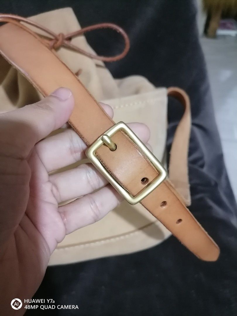 Timberland Suede Bucket Bag Tan Leather Strap (Category: Cross-body Bags) located in Naga. Submitted by mrwisethrifter (Listing ID 1468513930, Image 3). Description: - Brand: Timberland - Material: Soft tan suede with contrast stitching - Closure: Drawstring with leather cord - Strap: Adjustable shoulder strap with brass hardware - Interior: Clean with a zip pocket and signature tree logo pull - Condition: Excellent, functional hardware - Perfect