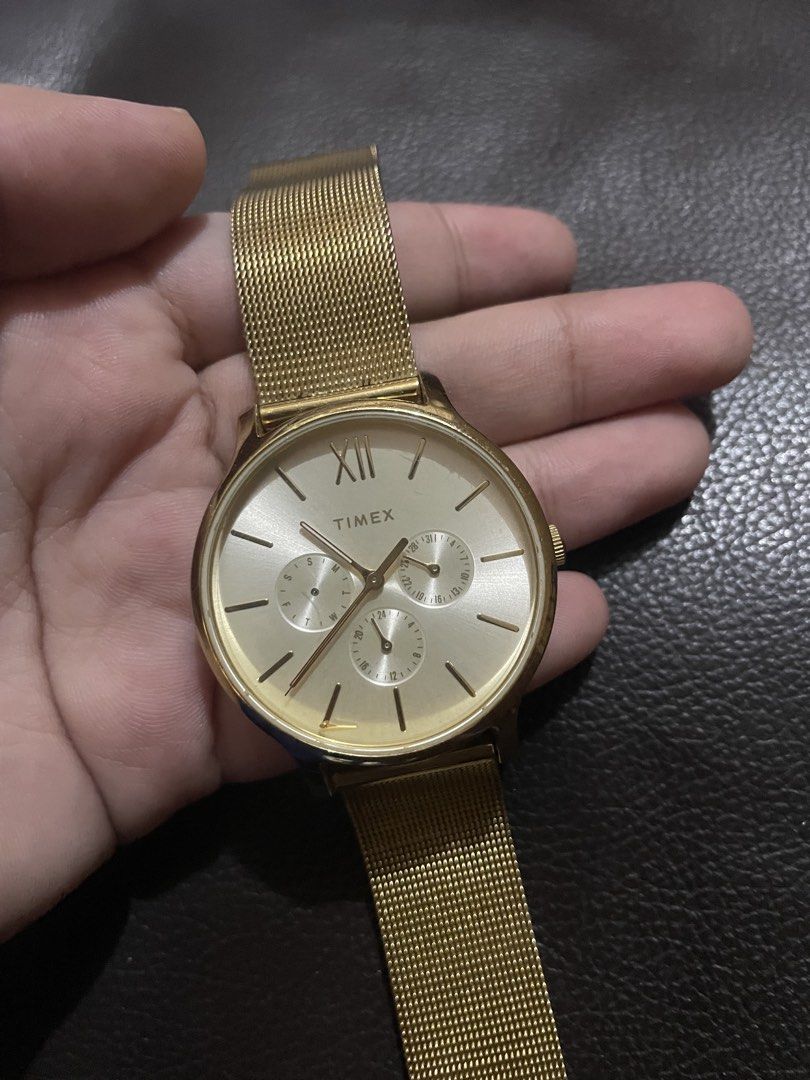 Timex Gold Mesh Chronograph Wristwatch (Category: Women's Watches) located in Mandaluyong City. Submitted by angelxx_ (Listing ID 1468705586, Image 2). Description: - Brand: Timex - Style: Gold-tone wristwatch with a modern mesh strap - Dial: Round featuring sub-dials and Roman numeral marker at 12 o'clock - Closure: Standard clasp - Condition: Minimal wear on casing and strap - Battery: Status unknown Honest Issue: Natanggal ung isang subdial pe