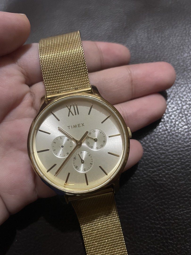 Timex Gold Mesh Chronograph Wristwatch (Category: Women's Watches) located in Mandaluyong City. Submitted by angelxx_ (Listing ID 1468705586, Image 3). Description: - Brand: Timex - Style: Gold-tone wristwatch with a modern mesh strap - Dial: Round featuring sub-dials and Roman numeral marker at 12 o'clock - Closure: Standard clasp - Condition: Minimal wear on casing and strap - Battery: Status unknown Honest Issue: Natanggal ung isang subdial pe