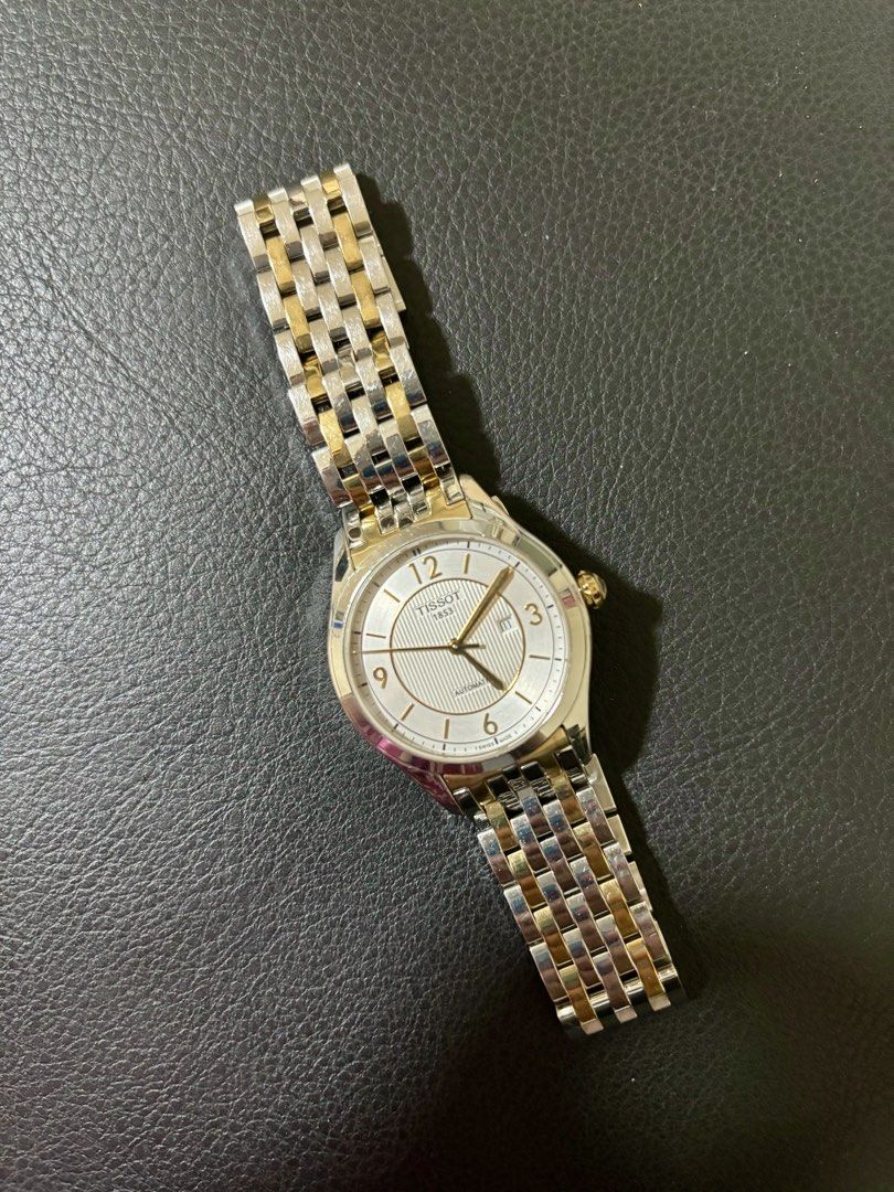 Tissot 1853 Automatic Two-Tone Watch (Category: Luxury Watches) located in Quezon City. Submitted by shopistas (Listing ID 1468538930, Image 2). Description: - Brand: Tissot 1853 - Movement: Automatic (No battery needed) - Origin: Swiss Made - Strap: Silver and gold two-tone bracelet - Dial: White textured with gold numerals at 12, 3, 6, and 9 - Features: Date window at 3 o'clock and gold crown - Condition: Excellent Rfs: Hindi nagagamit napag li