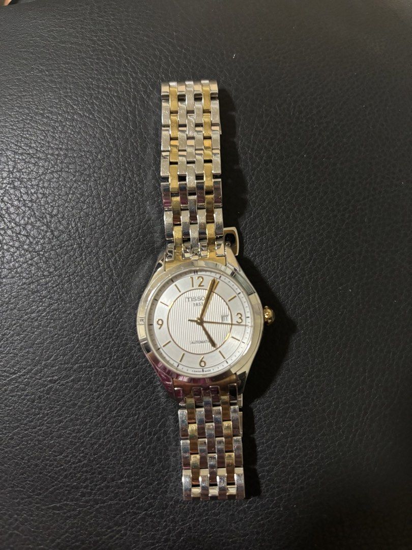 Tissot 1853 Automatic Two-Tone Watch (Category: Luxury Watches) located in Quezon City. Submitted by shopistas (Listing ID 1468538930, Image 1). Description: - Brand: Tissot 1853 - Movement: Automatic (No battery needed) - Origin: Swiss Made - Strap: Silver and gold two-tone bracelet - Dial: White textured with gold numerals at 12, 3, 6, and 9 - Features: Date window at 3 o'clock and gold crown - Condition: Excellent Rfs: Hindi nagagamit napag li