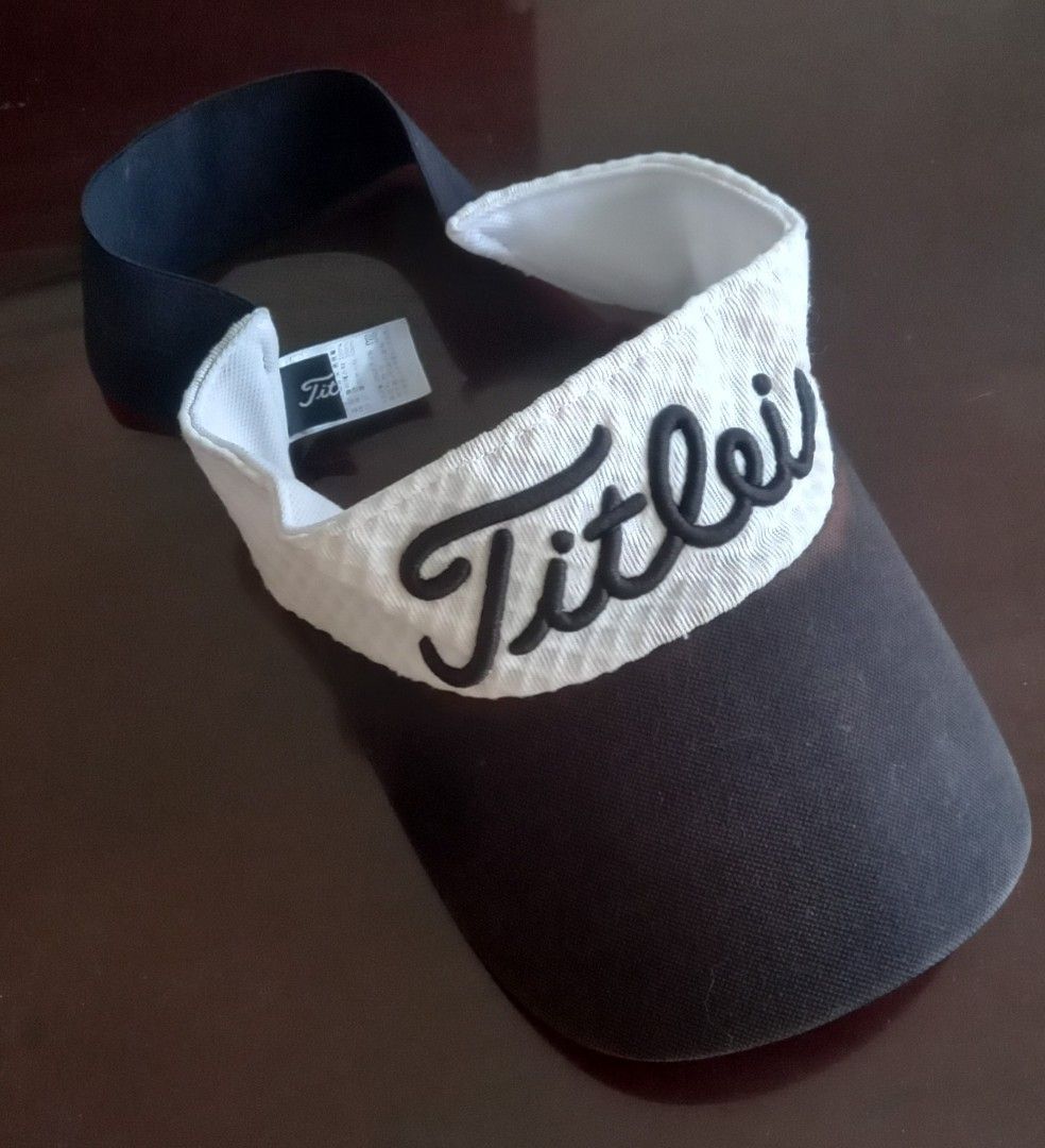 Titleist Golf Visor Black and White (Category: Golf) located in Cagayan de Oro. Submitted by edwardryan01984 (Listing ID 1468575408, Image 1). Description: - Brand: Titleist - Color: Classic black and white - Design: Raised black lettering on white front panel - Brim: Black curved brim - Fit: Comfortable elastic back strap - Condition: Brand new with attached tags and clean interior lining - Perfect for golf enthusiasts and sunny days on the cour