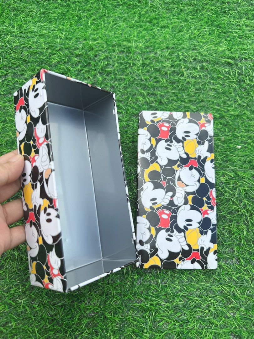 Tokyo Disney Resort Mickey Mouse Cookie Tin Box (Category: Vintage Collectibles) located in Manila. Submitted by ronoarabbit.ph (Listing ID 1468626612, Image 3). Description: Tokyo Disney Resort Mickey Mouse cookie tin box. All-over Mickey graphic print in black, white, yellow, and red. Steel container, clean inside. Rectangular shape with removable lid. Originally held chocolate sand cookies. Great for collecting Disney merchandise or storing sm