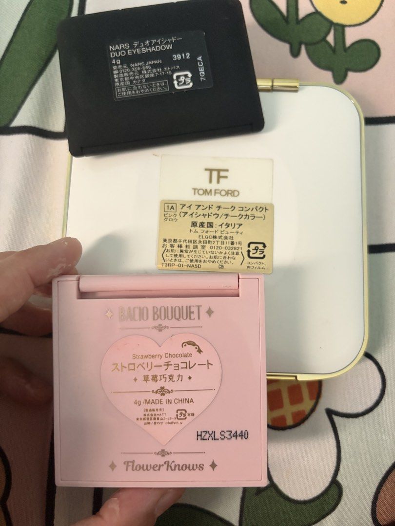 Tom Ford, NARS, and Flower Knows Makeup Palette Bundle (Category: Makeup) located in Tanza. Submitted by orcazairaj47526 (Listing ID 1468634613, Image 2). Description: - Makeup bundle featuring three popular beauty brands - Tom Ford cheek and eye compact with mirror - NARS Man Ray duo eyeshadow in original box with mirror - Flower Knows Strawberry Chocolate heart blush in pink with mirror - Perfect set for makeup lovers and collectors.