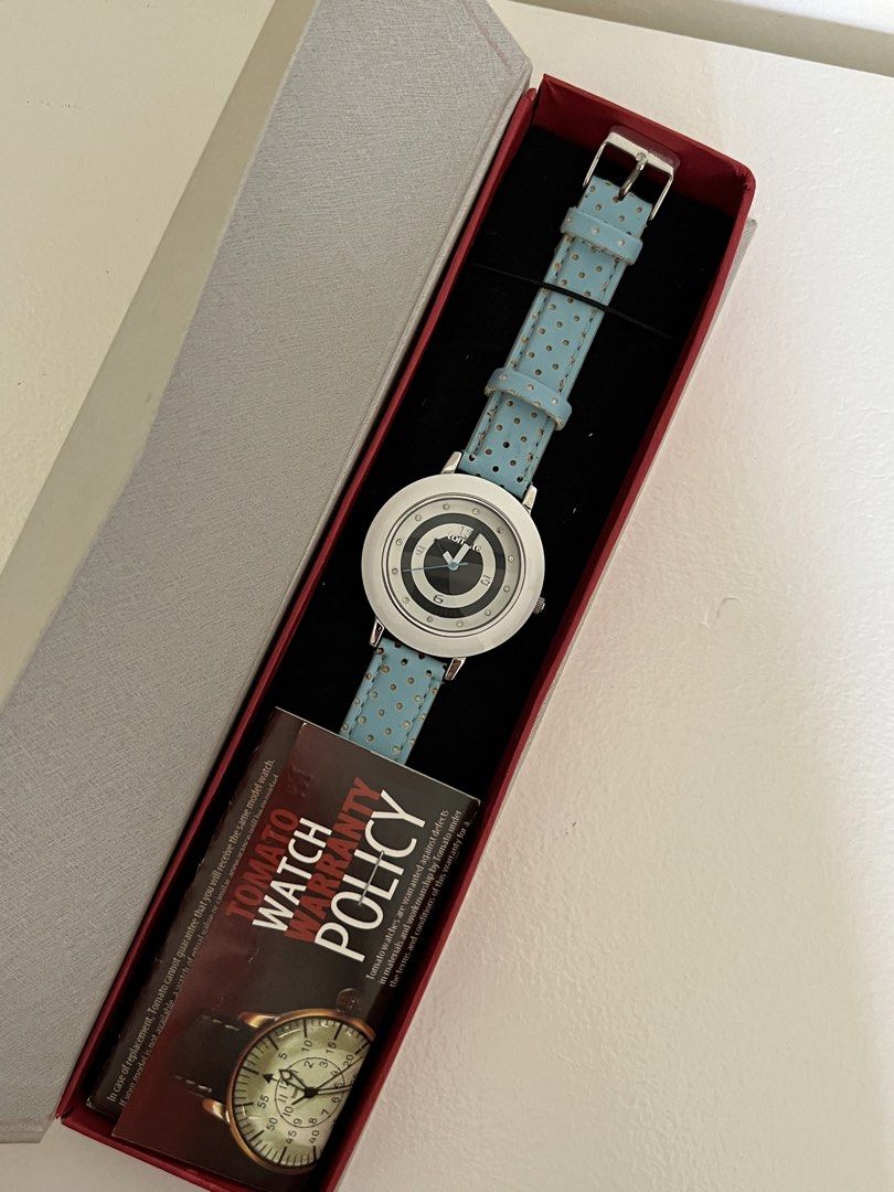 Tomato tiffany blue strap (Category: Women's Watches) located in Manila. Submitted by irish_closet (Listing ID 1468550671, Image 2). Description: White bezel, a black-and-white patterned dial featuring the brand logo (“tomto”), crystal-like accent markers, and a light blue strap with small polka dots.