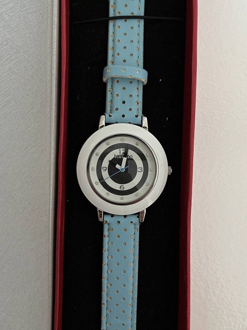 Tomato tiffany blue strap (Category: Women's Watches) located in Manila. Submitted by irish_closet (Listing ID 1468550671, Image 1). Description: White bezel, a black-and-white patterned dial featuring the brand logo (“tomto”), crystal-like accent markers, and a light blue strap with small polka dots.