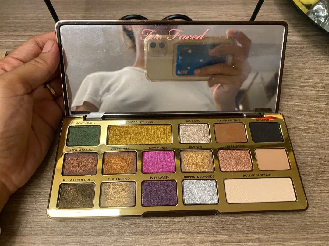 Too Faced Chocolate Gold Eyeshadow Palette (Category: Makeup) located in Makati City. Submitted by larasdowry (Listing ID 1468710722, Image 2). Description: Authentic Too Faced Chocolate Gold Eyeshadow Palette in a stunning gold drip metal case with a built-in mirror. Features 16 rich metallic and matte shades like Money Bags, New Money, Rich Girl, and Decadent. Perfect for creating glam looks!.