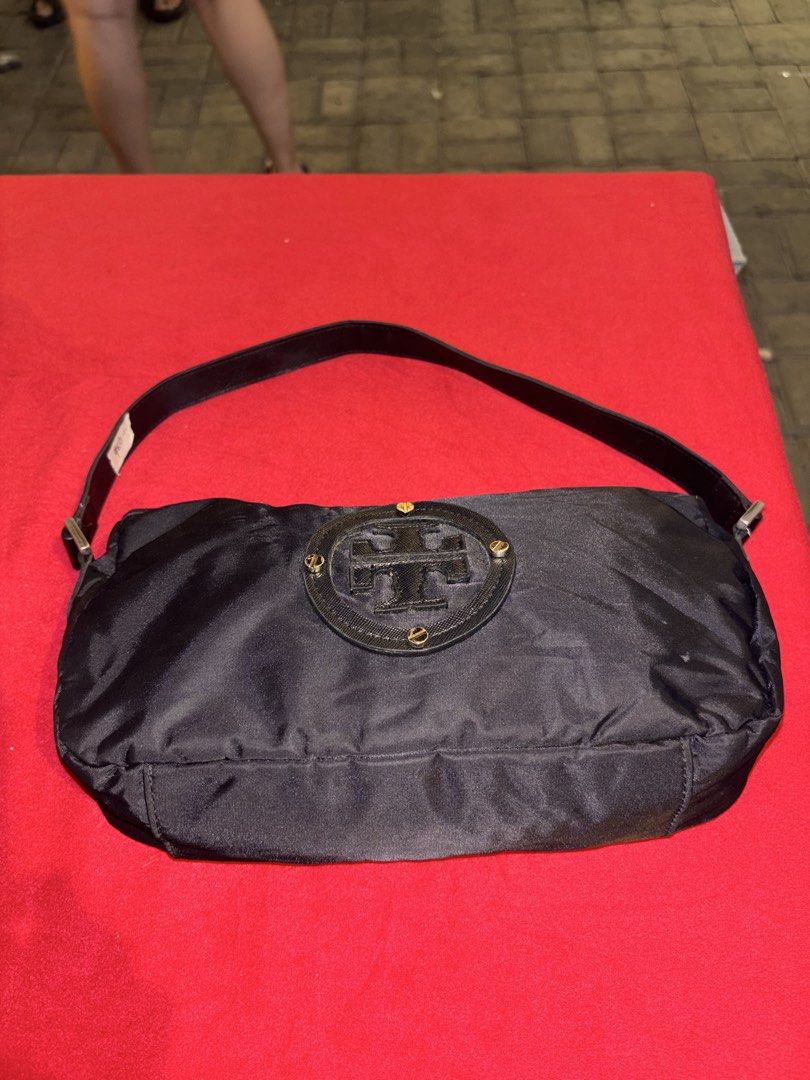 Tory Burch Black Nylon Shoulder Bag (Category: Luxury Bags & Wallets) located in Manila. Submitted by jeromskito66462 (Listing ID 1468670248, Image 2). Description: - Brand: Tory Burch vibes - Material: Durable black nylon - Hardware: Elegant gold-tone accents with circular logo plaque - Closure: Secure top zipper - Interior: Clean fabric lining with convenient slip pockets - Condition: Clean inside and out, ready to use.