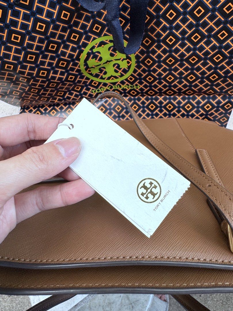 Tory Burch Emerson Large Tote Moose Brown (Category: Tote Bags) located in Quezon City. Submitted by gorjuspots (Listing ID 1468704611, Image 3). Description: - authebtic with original store tags attached (bought from Canada) - Authentic Tory Burch Emerson large tote in a versatile moose brown color - Crafted from durable and clean saffiano leather with elegant gold hardware - Structured design with comfortable top handles - Spacious interior eas