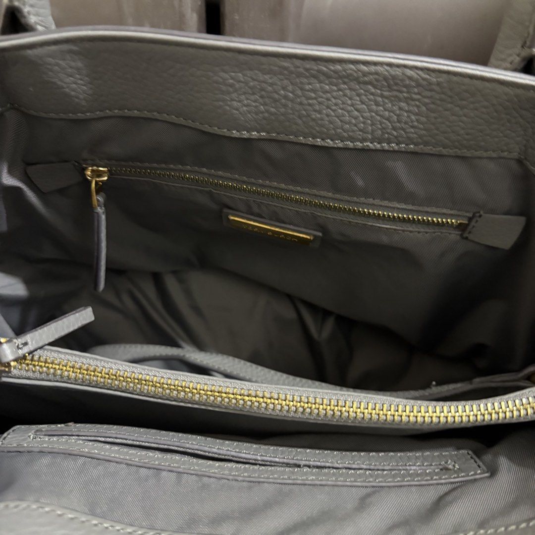Tory Burch Gray Leather Tote Bag (Category: Tote Bags) located in Rizal. Submitted by lovegclothingph (Listing ID 1468651202, Image 3). Description: - Brand: Tory Burch - Material: Premium gray pebbled leather with gold-tone hardware - Design: Embossed double T logo and decorative stitching - Straps: Dual carry handles + detachable shoulder strap - Interior: Fabric-lined with zipper pockets and gold brand plaque - Condition: With signs of usage (