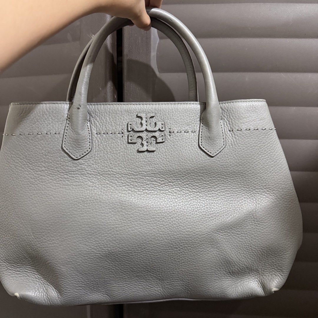 Tory Burch Gray Leather Tote Bag (Category: Tote Bags) located in Rizal. Submitted by lovegclothingph (Listing ID 1468651202, Image 1). Description: - Brand: Tory Burch - Material: Premium gray pebbled leather with gold-tone hardware - Design: Embossed double T logo and decorative stitching - Straps: Dual carry handles + detachable shoulder strap - Interior: Fabric-lined with zipper pockets and gold brand plaque - Condition: With signs of usage (