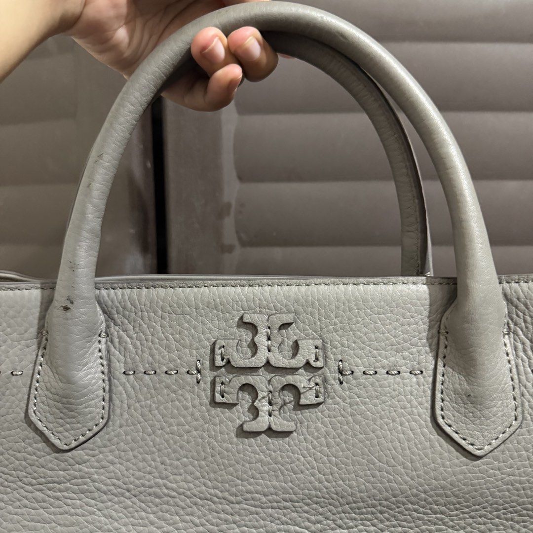 Tory Burch Gray Leather Tote Bag (Category: Tote Bags) located in Rizal. Submitted by lovegclothingph (Listing ID 1468651202, Image 2). Description: - Brand: Tory Burch - Material: Premium gray pebbled leather with gold-tone hardware - Design: Embossed double T logo and decorative stitching - Straps: Dual carry handles + detachable shoulder strap - Interior: Fabric-lined with zipper pockets and gold brand plaque - Condition: With signs of usage (