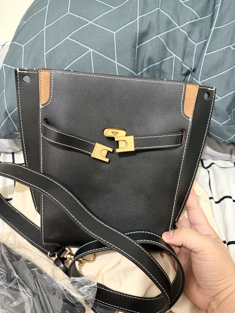Tory Burch Lee Radzwill Petite Bucket Bag (Category: Shoulder Bags) located in San Fernando. Submitted by ydmem (Listing ID 1468556927, Image 2). Description: - Material: Premium black leather with stylish suede accent panels - Details: Eye-catching contrasting white stitching and polished gold turn-lock closure - Interior: Clean dark fabric lining with convenient zip and slip pockets - Straps: Includes an adjustable shoulder strap plus a separat