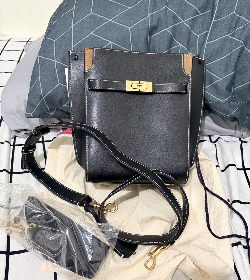 Tory Burch Lee Radzwill Petite Bucket Bag (Category: Shoulder Bags) located in San Fernando. Submitted by ydmem (Listing ID 1468556927, Image 1). Description: - Material: Premium black leather with stylish suede accent panels - Details: Eye-catching contrasting white stitching and polished gold turn-lock closure - Interior: Clean dark fabric lining with convenient zip and slip pockets - Straps: Includes an adjustable shoulder strap plus a separat