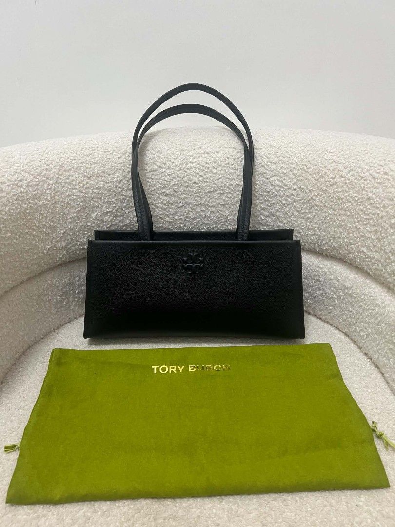 Tory Burch Thea East West Shoulder Bag (Category: Shoulder Bags) located in Paoay. Submitted by rvf1230 (Listing ID 1468545544, Image 3). Description: - Authentic Tory Burch black leather shoulder bag - Structured rectangular shape with a minimalist design - Subtle debossed logo on the front face - Comfortable thin shoulder straps - Clean edge and base stitching - Spacious interior for all your daily essentials - Condition: Excellent / Grab it be