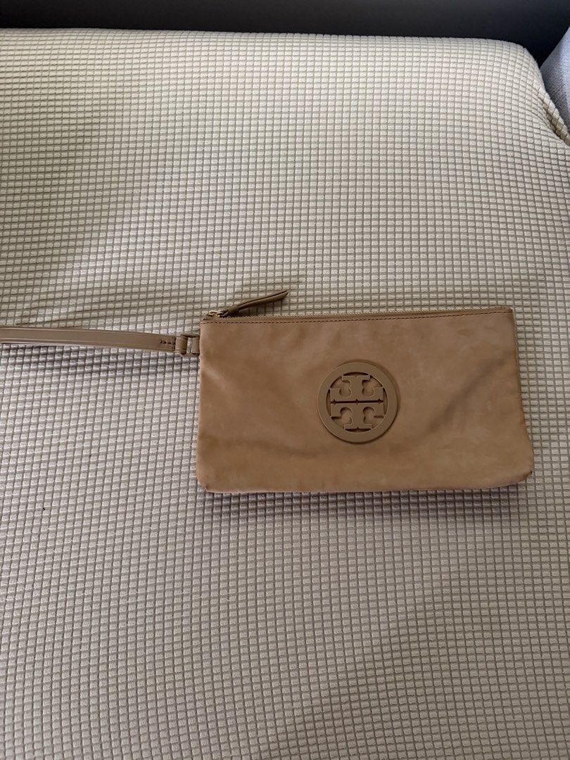Tory Burch Wristlet Clutch Tan Leather (Category: Luxury Bags & Wallets) located in Paranaque City. Submitted by balofies (Listing ID 1468661305, Image 1). Description: - Brand: Tory Burch - Material: Premium tan leather with fabric-lined interior - Features: Matching wrist strap, embossed logo circle, secure zip top closure - Condition: Overall clean inside and out, with a few tiny scuffs near the bottom back edge - Usage: Compact size, ideal fo