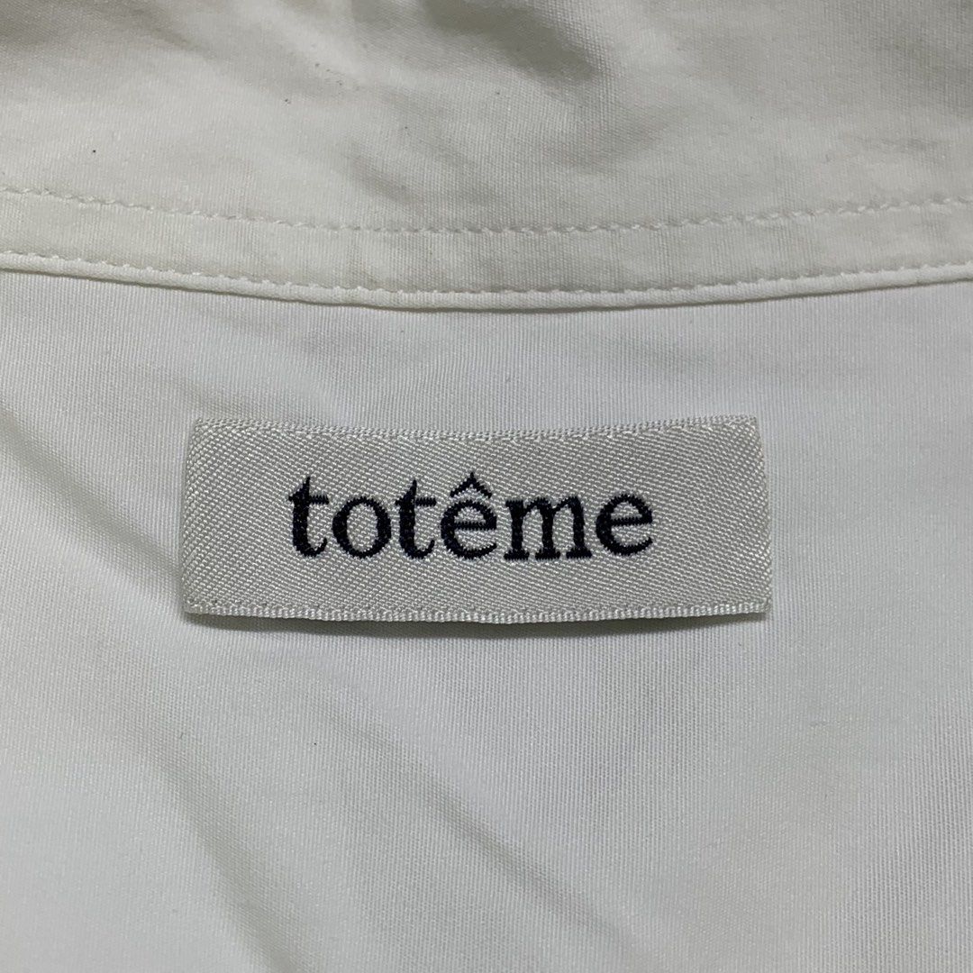 TOTEME - long-sleeve button-up (Category: Longsleeves) located in Manila. Submitted by shottas_21 (Listing ID 1468519726, Image 3). Description: TOTEME - long-sleeve button-up SIZE - Xsmall CONDITION - 9/10 FLAW - washable stain Made in Portugal 100% Cotton CHEST - 21” LENGTH - 28.5” SHOULDERS - 17” SLEEVE - 23.5” HEM - 21”.